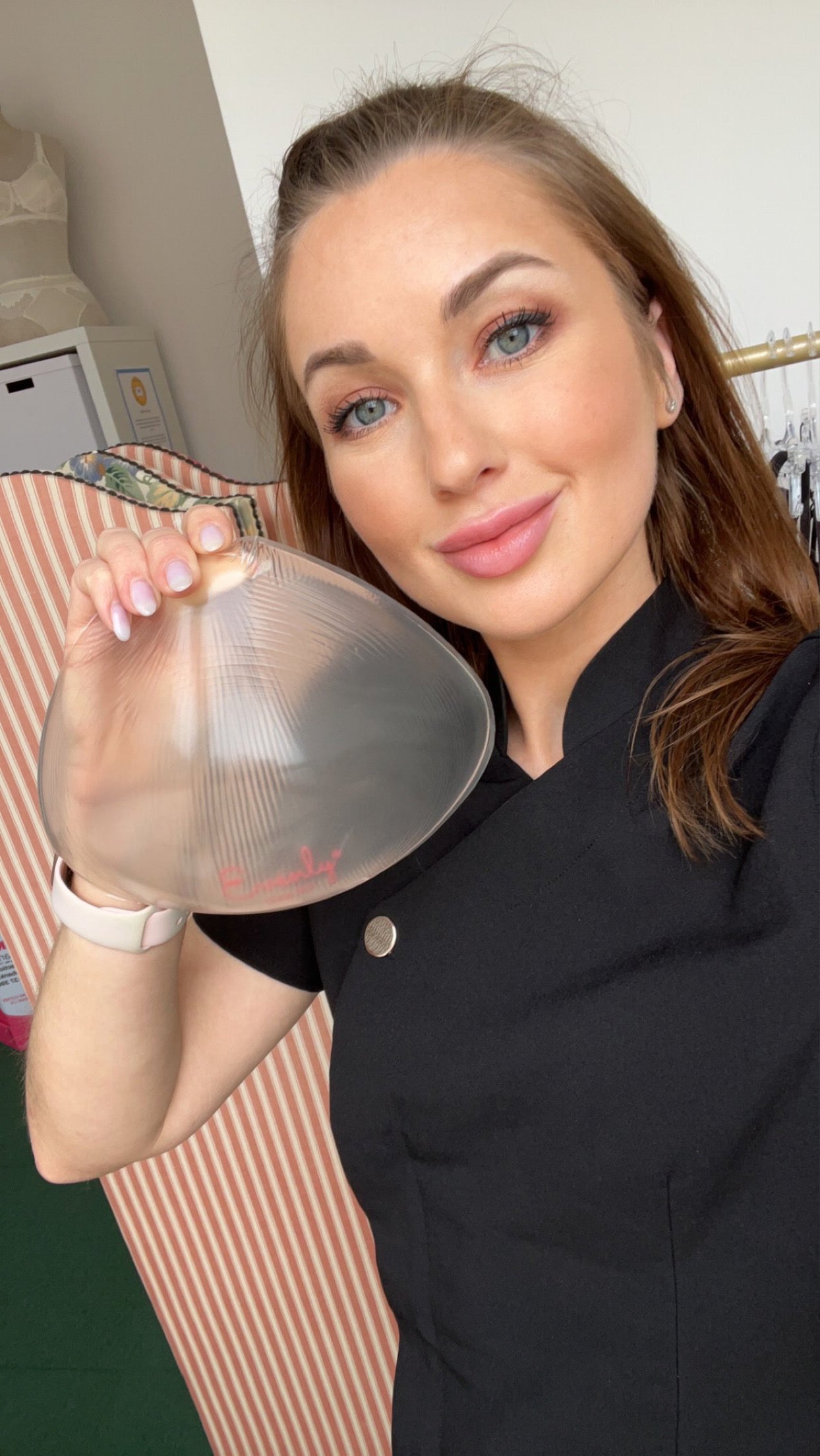 Amy, owner of the fitting service holding an evenly bra balancer