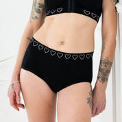 woman wearing cancer research briefs in black