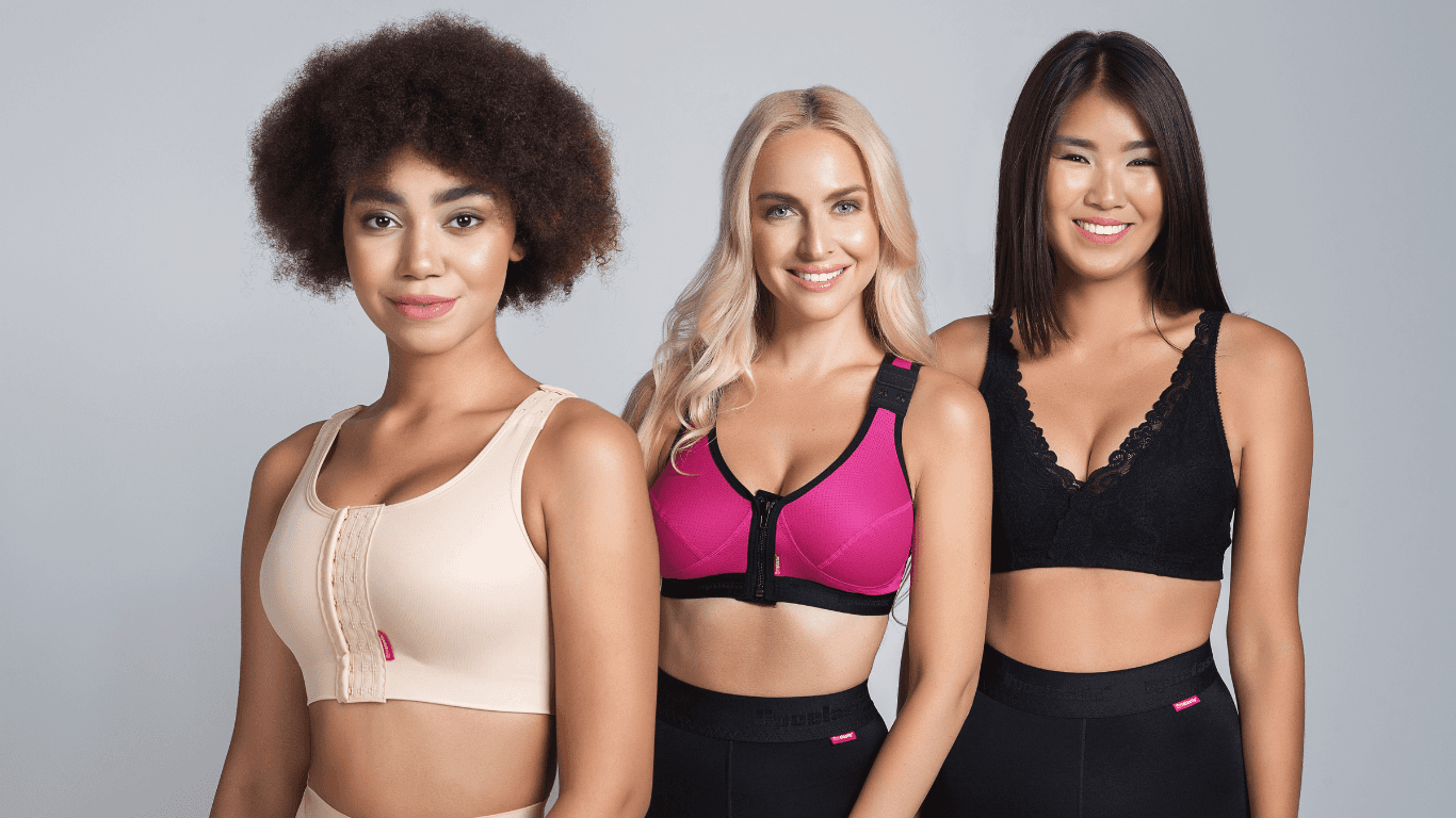 Three Ladies wearing Lipoelastic garments, from the left, the lady is wearing the PI ideal . the lady in the middle is wearing the pink PI unique which is a second stage post surgery bra and the lady on the right is wearing the PI premium which is lace