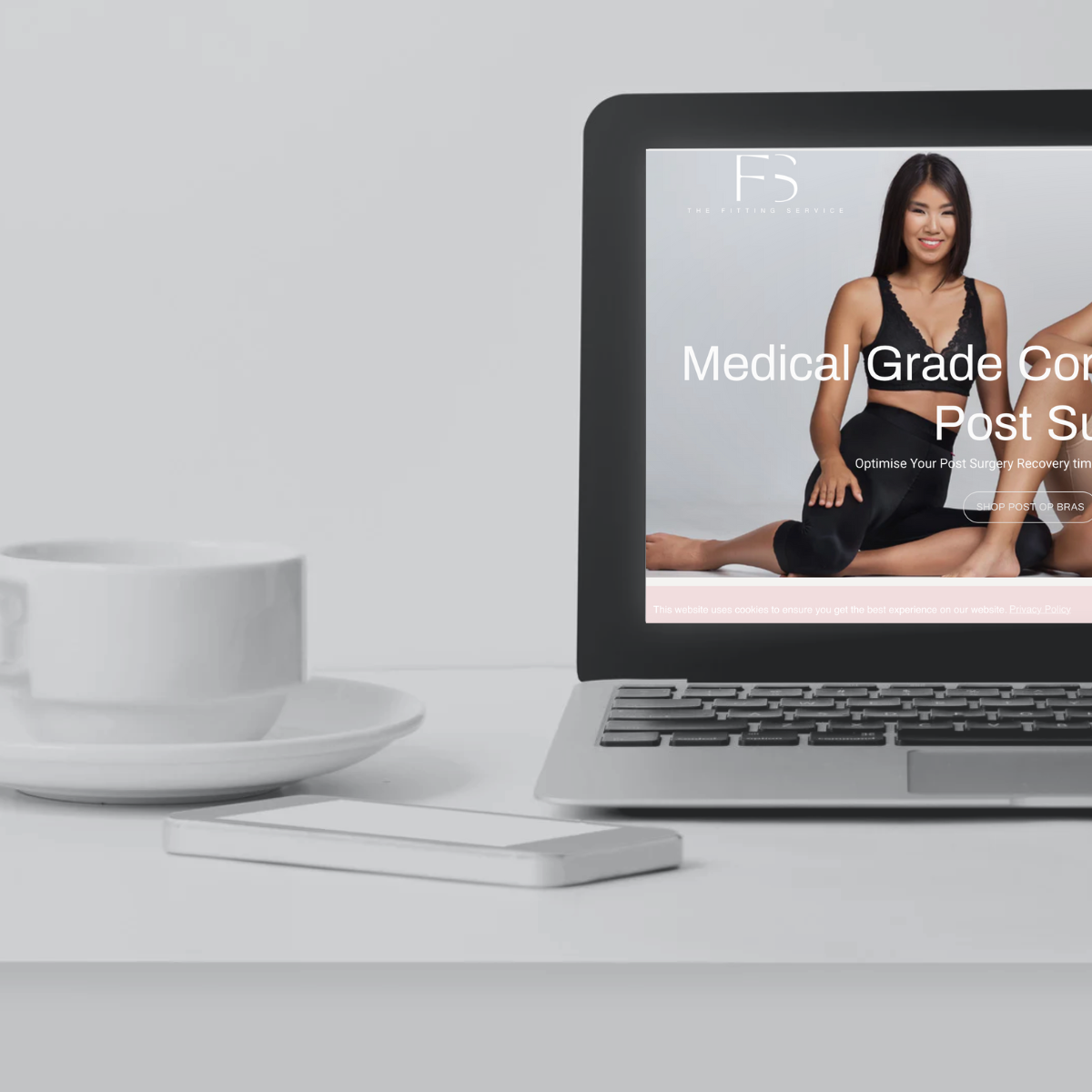 image showing a laptop and coffee with the fitting service website on the screen