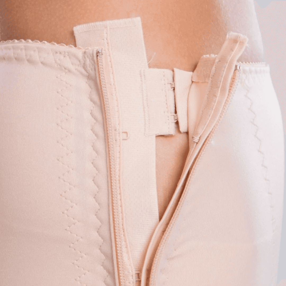 Discover the TF Comfort Garment, ideal for post-operative recovery after liposuction. Suitable for lower tummy, buttocks, pelvic area, hips, and thighs. Offers optimal compression and support. Double-lined fabric reinforces the lower abdomen. Soft lace hem prevents rolling or squeezing. Convenient zipper closures on both sides for easy dressing. Experience comfort and confidence in your recovery journey