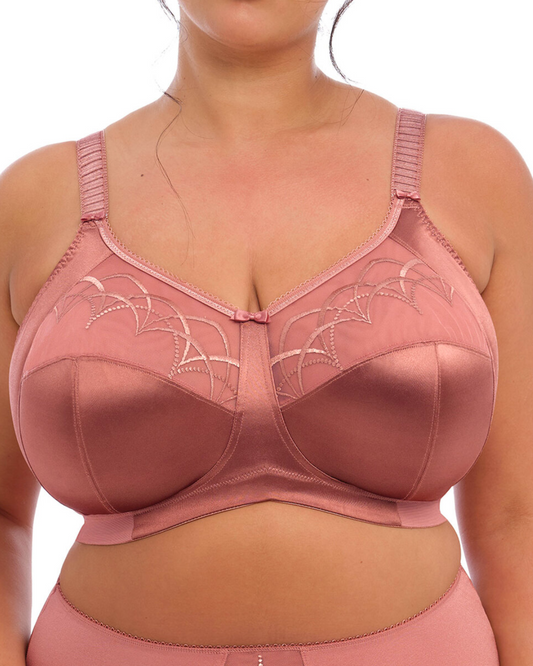 Elomi Cate Soft Cup Bra in Rosewood with sheer embroidery, soft satin cups, and an intersecting arc design. The bra offers three-piece cups with side support for shaping, uplift, and separation. It features a wide elastic underband, flexible side boning, and powernet wings for enhanced support. Complete with charming bow details, this bra combines elegance and comfort.