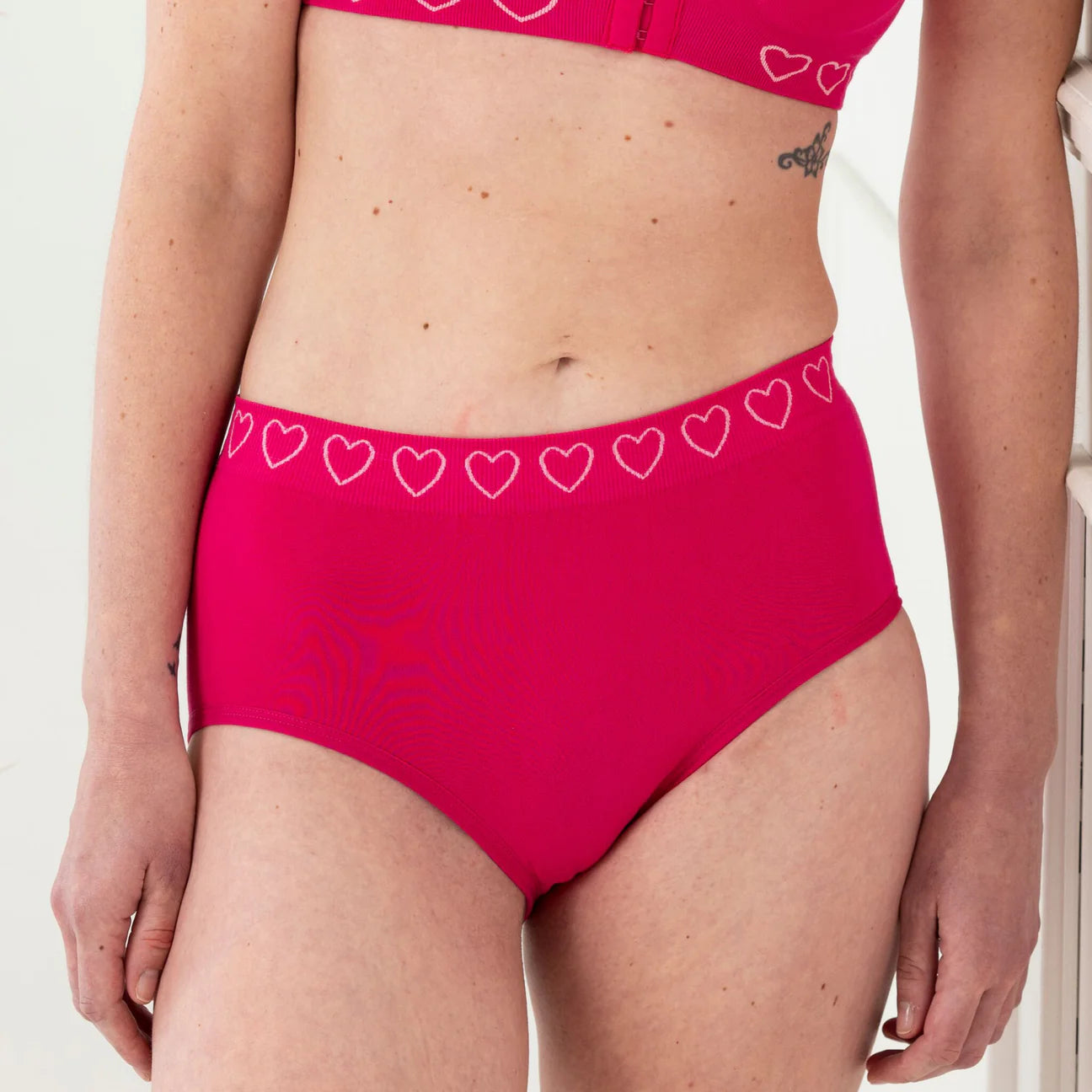 woman wearing pink cancer research brief suitable for post surgery use