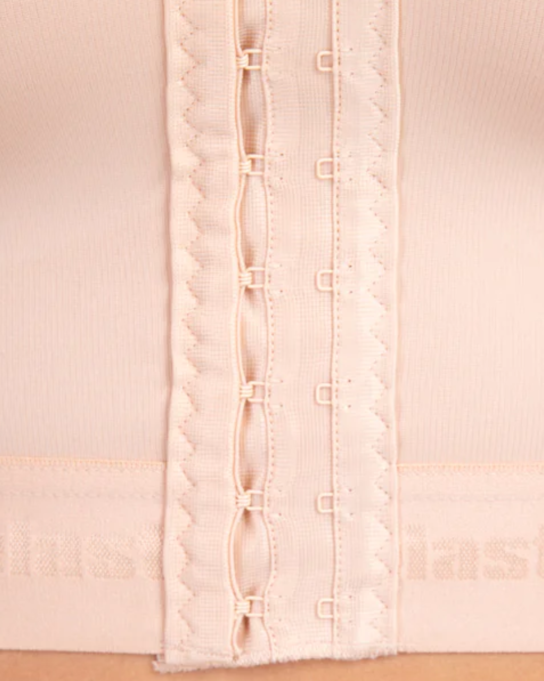 Detail shot of MT Smooth Variant front fastening – three rows of hook-and-eye closures