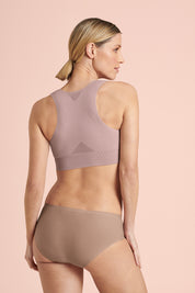 Back of anita almeria compression garment showing breathable zones for comfort and heat regulation, the bra has a razor back design for support post surgery