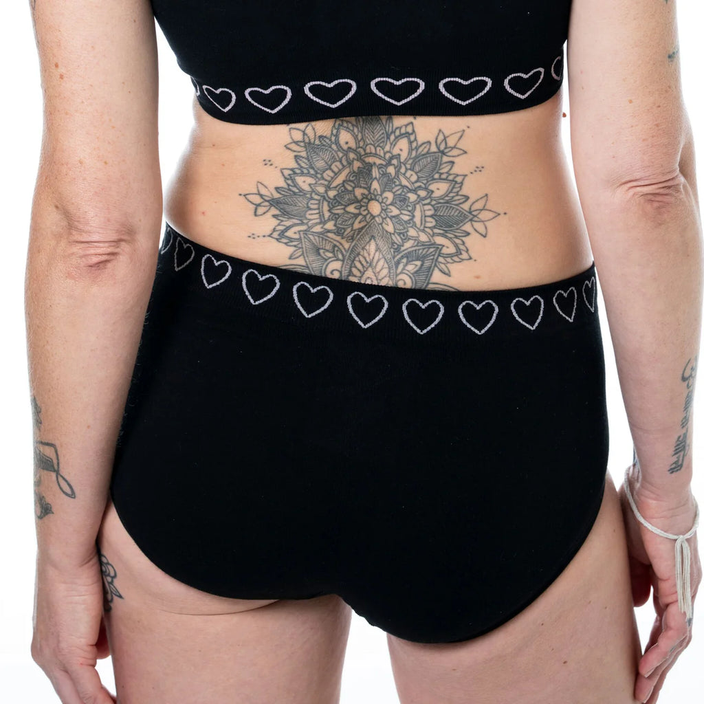 woman wearing the black cancer research brief image showing the back of the knicker