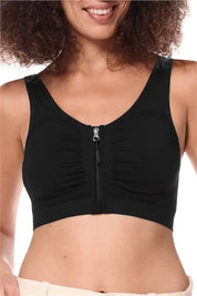 Amoena post surgery bra, Emilia,  an adjustable strap bra with bilateral pockets for prosthesis, front zip closure, and integrated mesh panels. It is suitable for breast surgeries like reconstruction, reduction, augmentation, and mastectomy. The garment also features a hook and loop fastener flap for compression belt attachment. Experience gentle support with the Amoena Emilia post surgery bra 