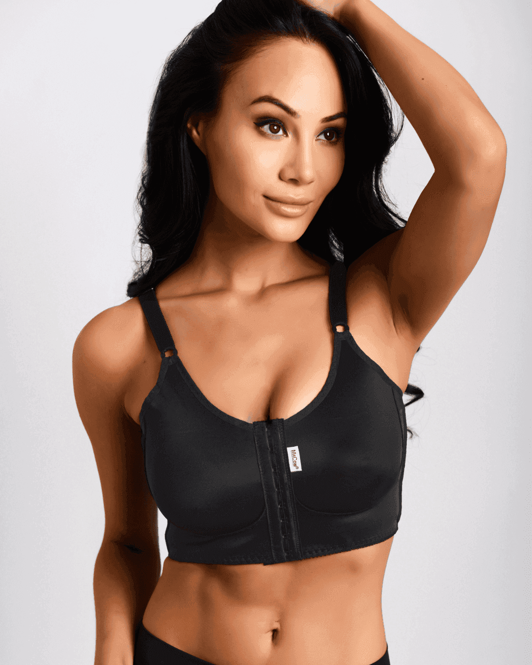The Macom i bra post operative bra in black This Macom bra  is the most supportive post surgery bra from the Macom range. It is ideal for larger implants (350cc or larger) The i-Bra is suitable for anatomical implants and helps prevent implant rotation. The compression around the back will not only stabilise the implant but also will help to minimise swelling. 